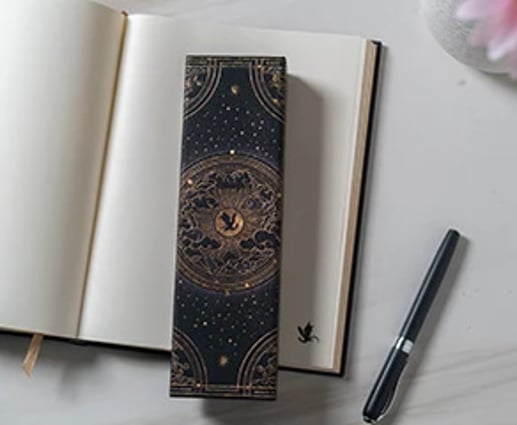 A fourth wing pencil case on top of an open cahier.